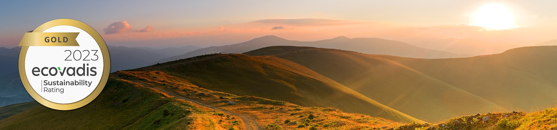 Liebherr Sustainability Banner showing rising sun on a valley landscape